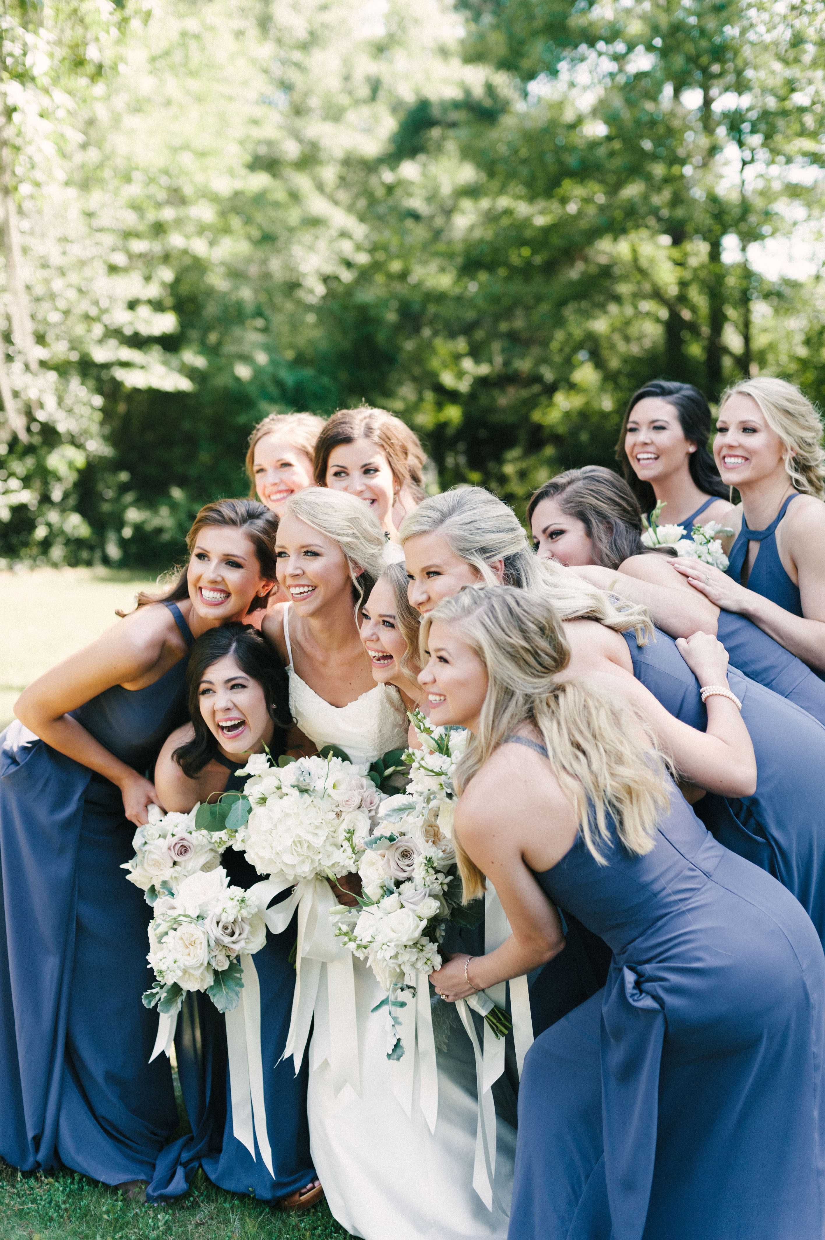 A really cute capture of a bride posing with ecstatic bridesmaids before Selma, Alabama wedding