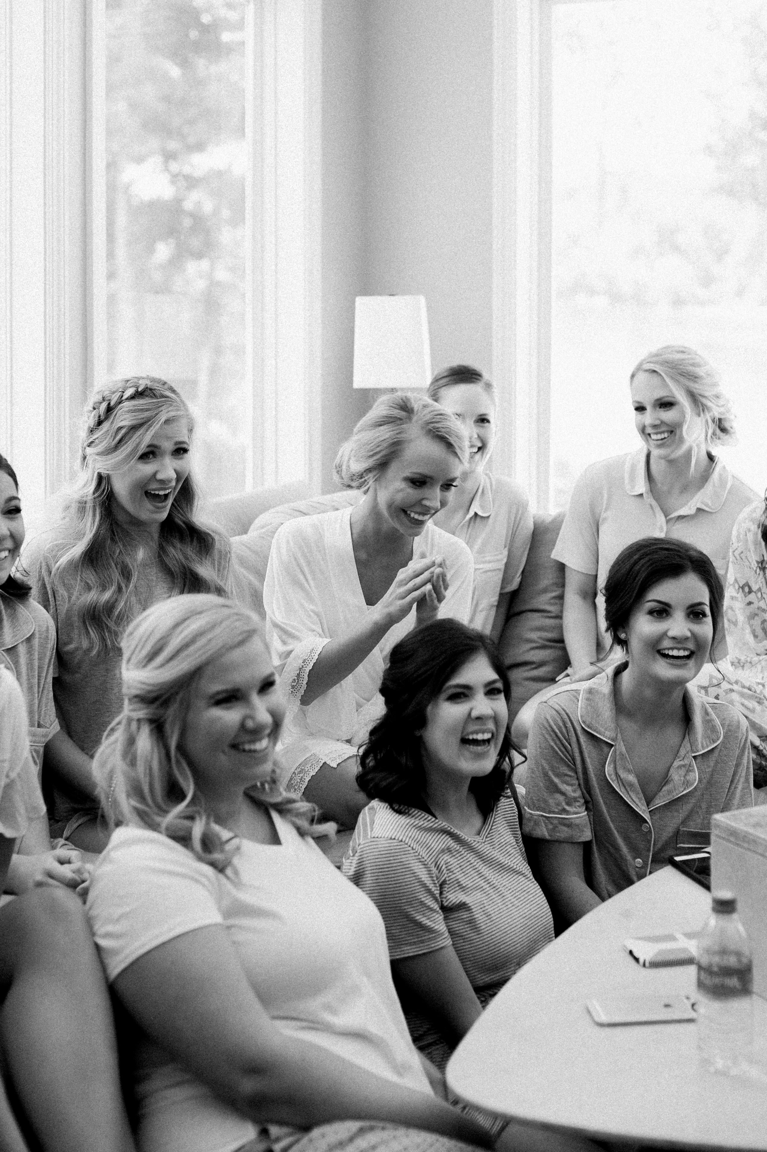 Bride and bridesmaids laughing and having a good time while they're getting ready in an Selma, AL wedding