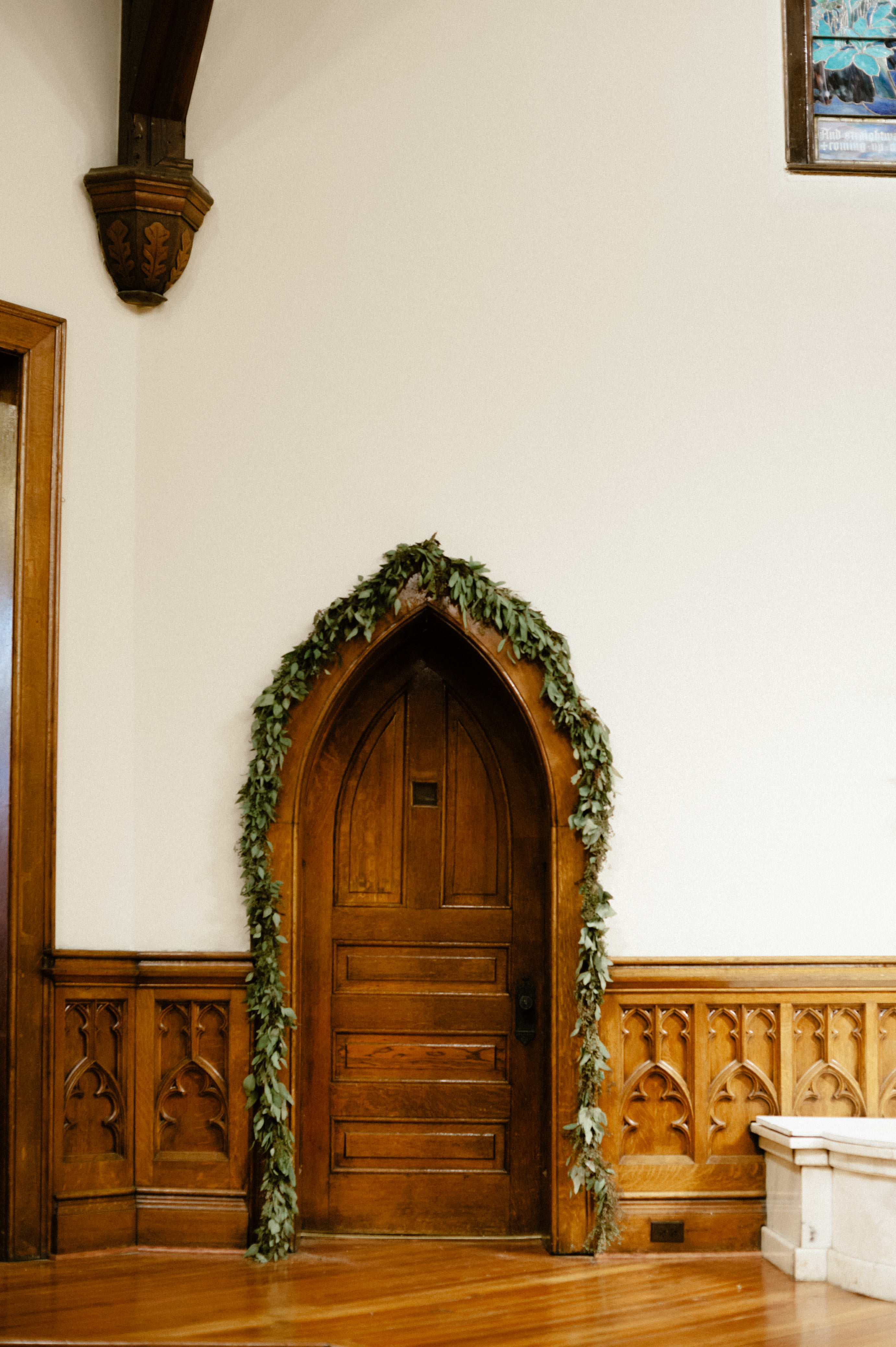 a stunning photo capture of architecture in First Baptist Church historical doorway greenery arrangement for a wedding in Selma, AL