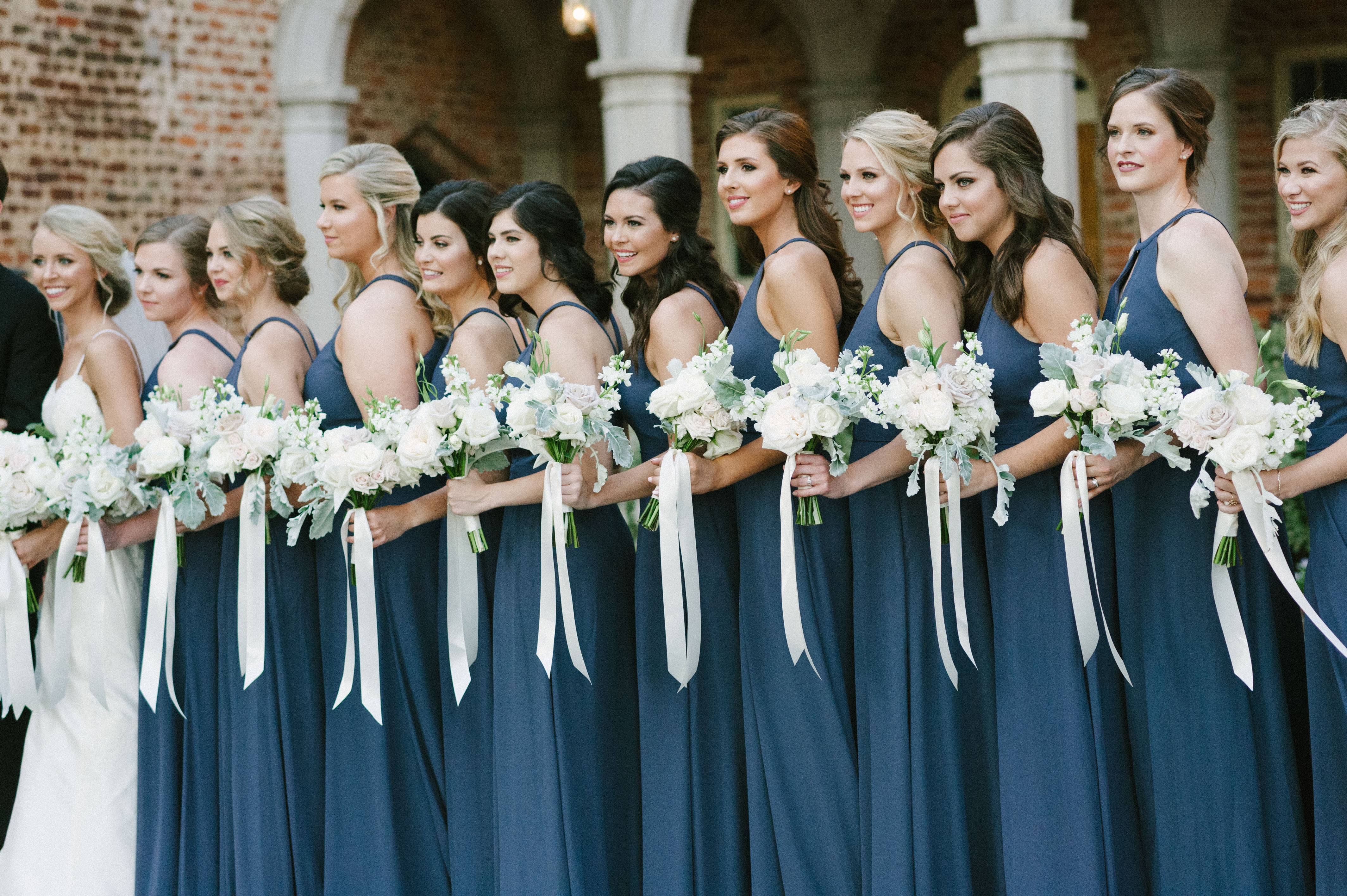 Amazingly stunning photo in Portra 400 film photo edit of bridal party in their indigo dresses at First Baptist Church in Selma, AL by Olivia Joy Photography