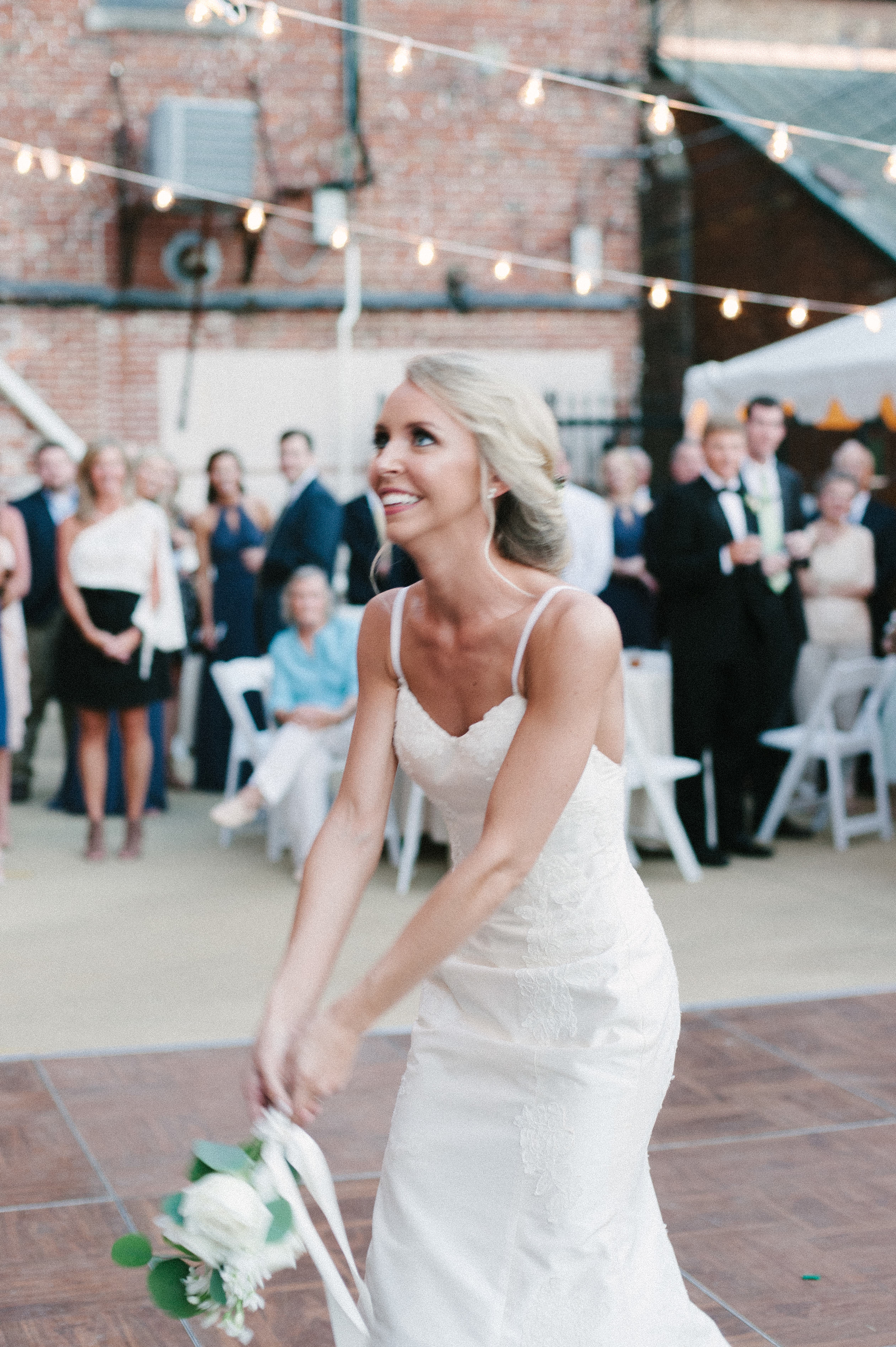 A motion blur film photo edit of a Selma, AL bride tossing her bouquet on her wedding day at First Baptist Church. Portra 400 edit by Olivia Joy Photography