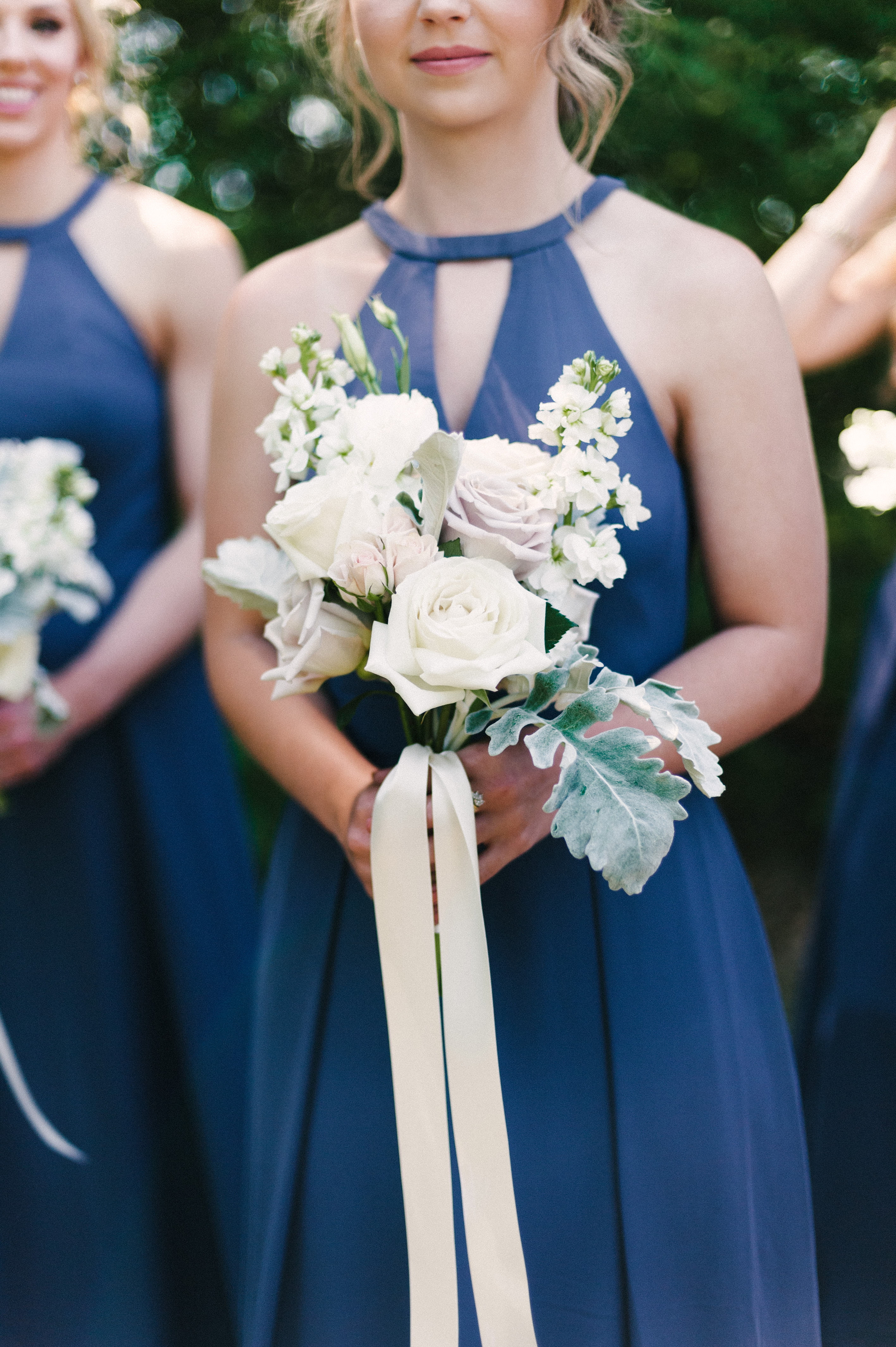 Stunning bridesmaid holding ethereal bouquets with long ribbon for a timeless wedding in Selma, AL