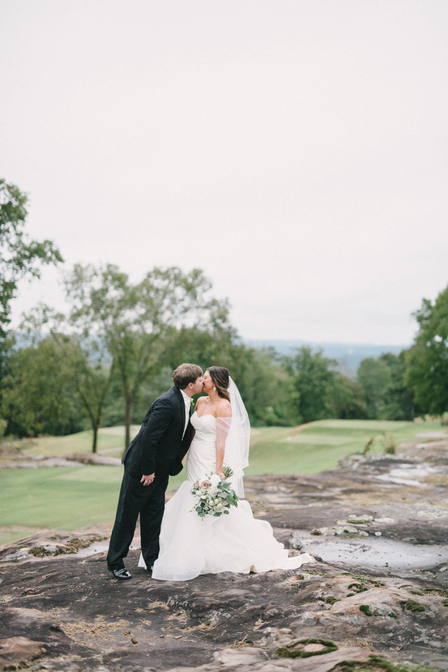 Bride and groom kissing outside Vestavia Hills Country Club