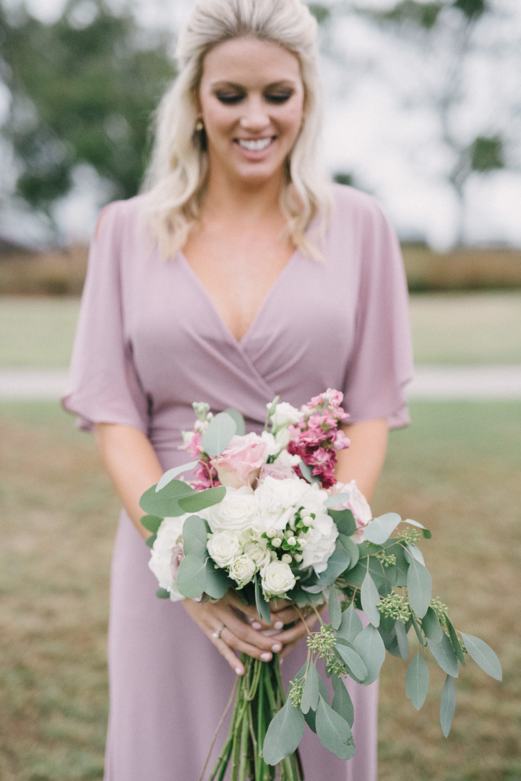 Bridesmaid posing with bouquet at Vestavia Hills Country Club wedding