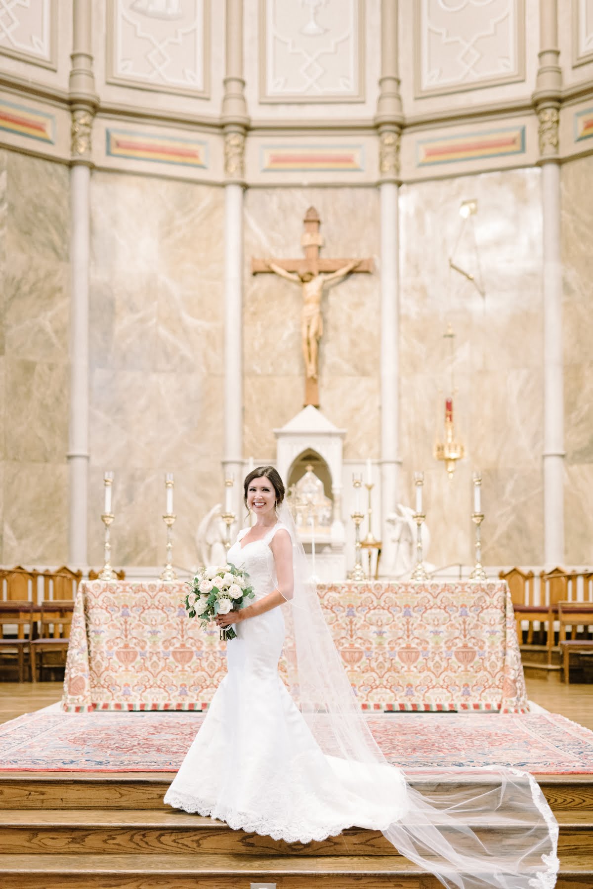 Bride in gown beneath crucifix