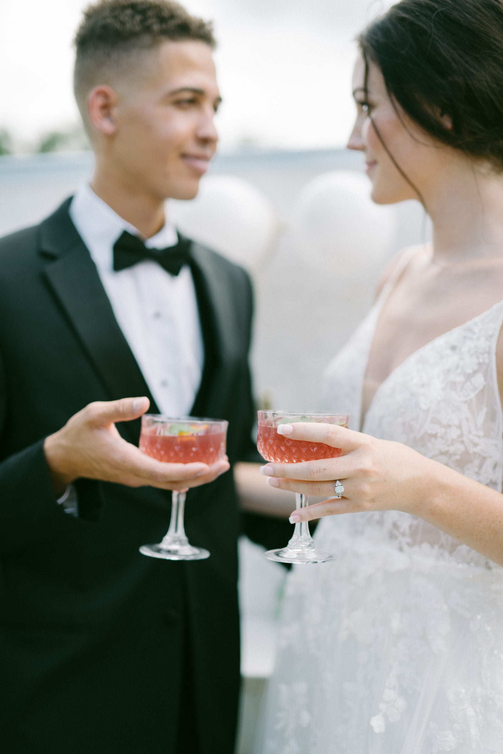 A photo of a Wedding couple smiling and each other enjoying cocktail at Pursell Farms wedding venue in Alabama