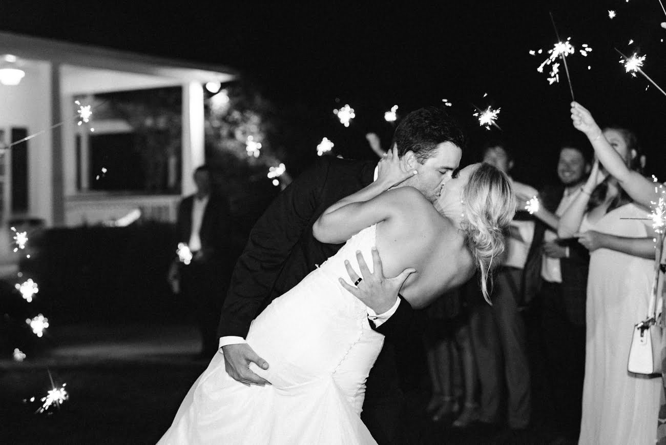 Sparkler kissing wedding send off photo