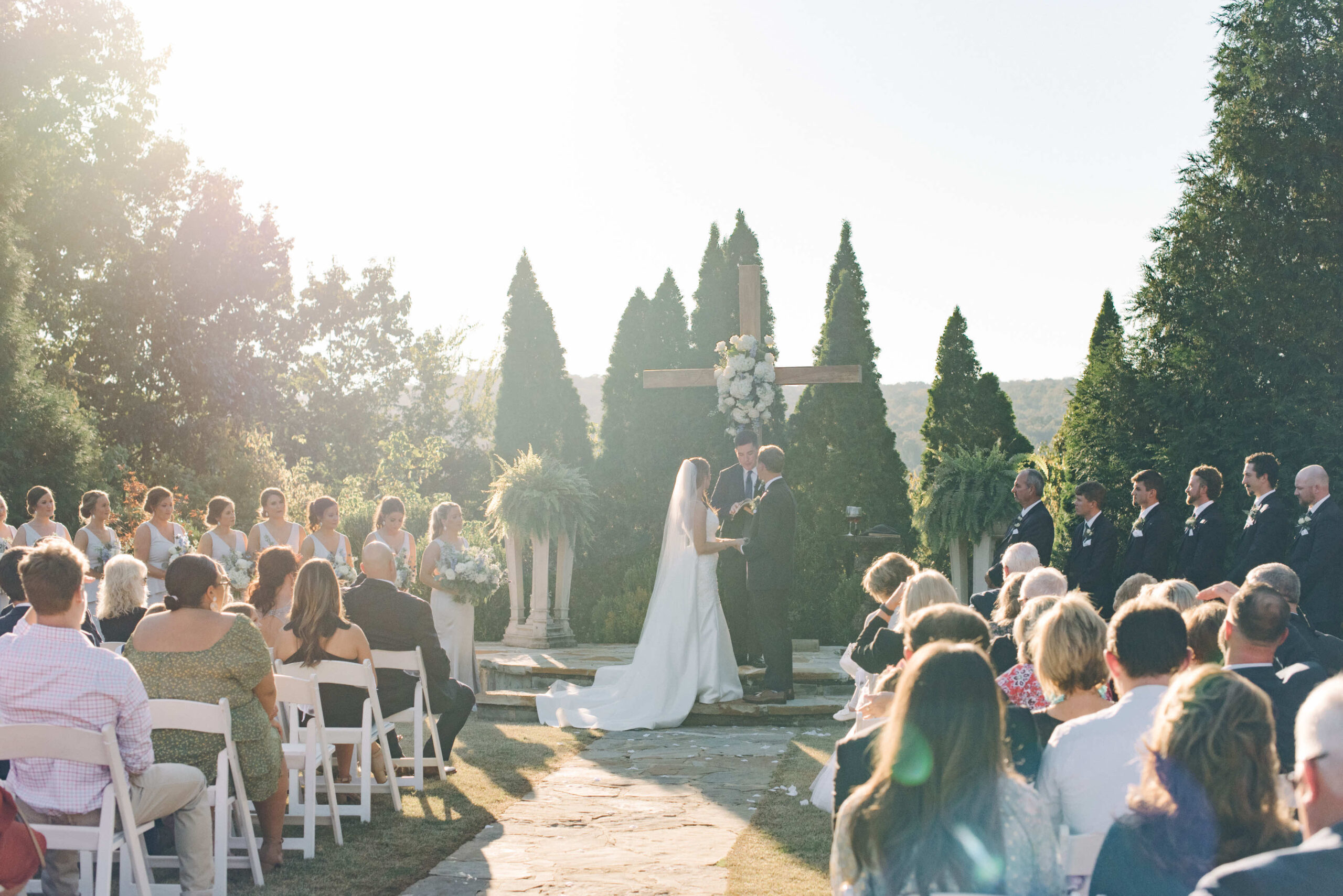 A dreamy film edit photo of a wedding ceremony at sunset in the Gardens at Park Crest Events wedding venue in Hoover, AL