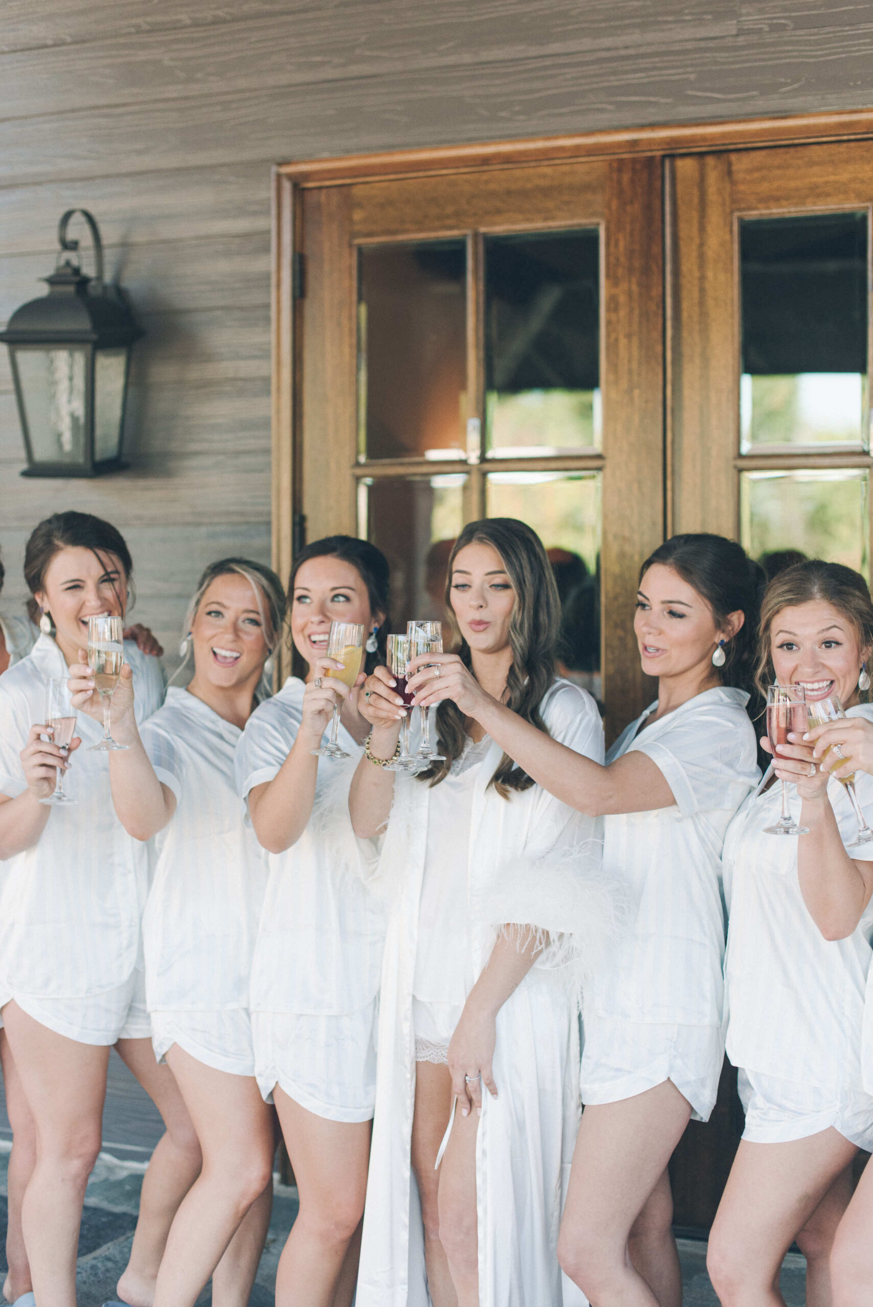 Bridal party at Park Crest Events wedding venue facility toasting with mimosas to celebrate their friend getting married